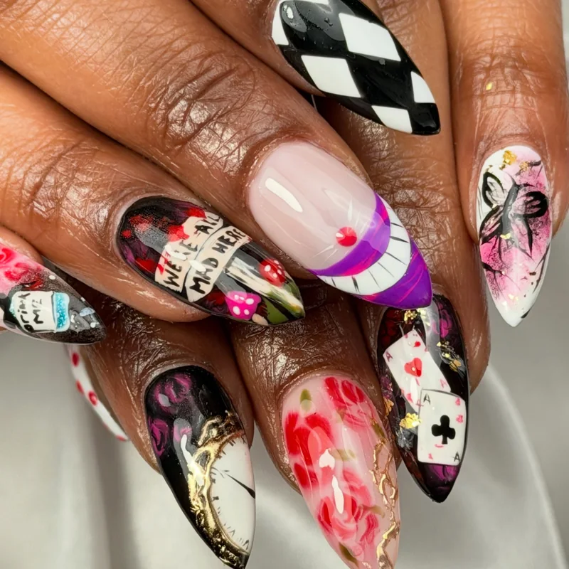 Long almond nails with colorful illustrated details, black-and-white checks, playing cards, and pink accents.