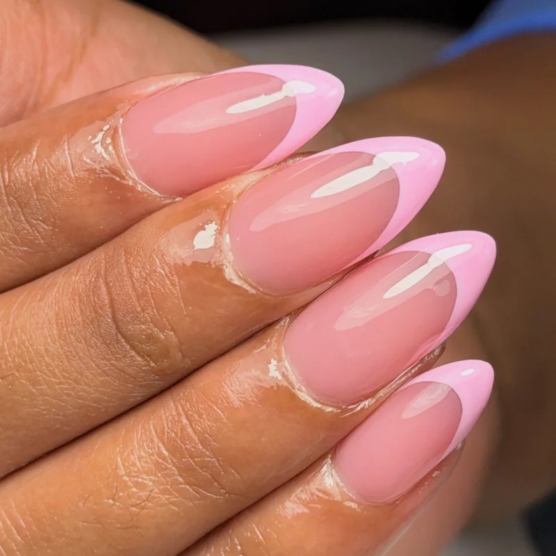 Glossy almond nails with a sheer pink base and pale pink French tips.